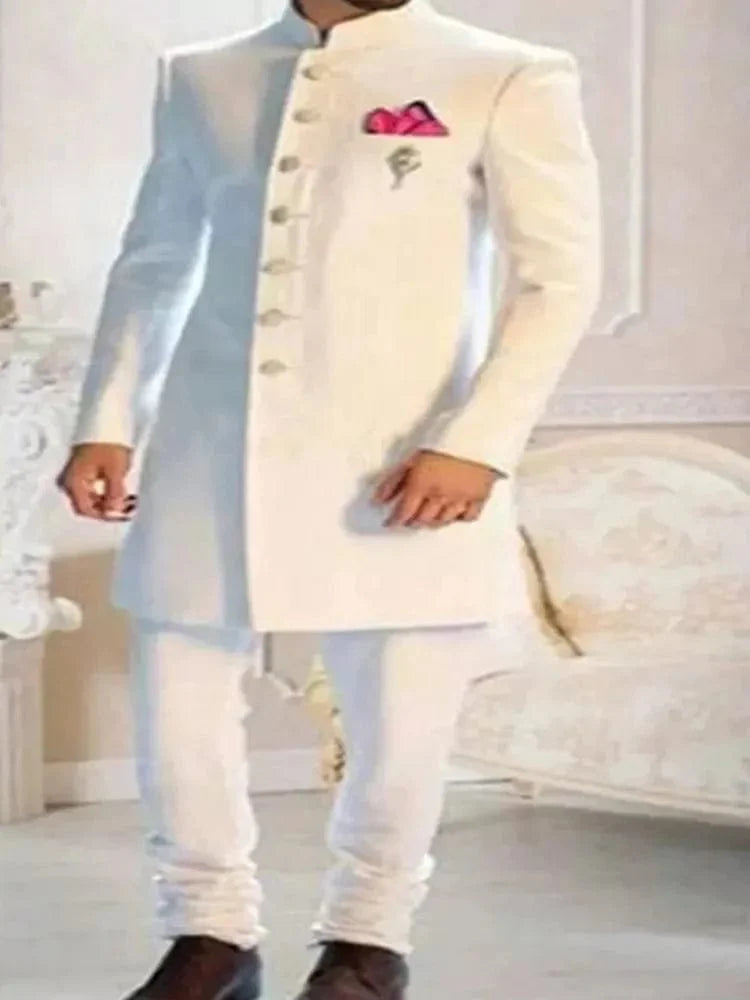 White Indian tuxedo for men, slim fit wedding suit with stand collar, single-breasted design, formal ethnic Indian groom attire.