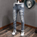 Light blue slim fit ripped denim jeans for men by Showlu Fashion, featuring a retro style, stretch fabric, and casual vintage design.