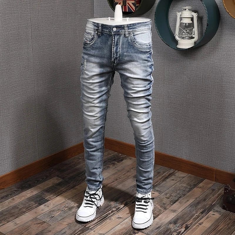 Light blue slim fit ripped denim jeans for men by Showlu Fashion, featuring a retro style, stretch fabric, and casual vintage design.