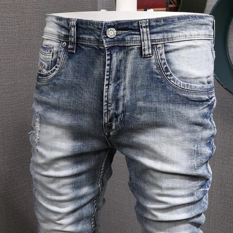 Showlu Men's light blue slim fit ripped stretch denim jeans with vintage design and casual style, featuring distressed details and holes.