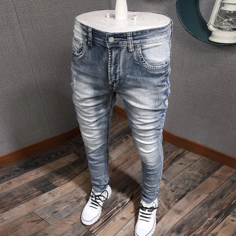 Light blue slim fit men's ripped stretch denim jeans with vintage style and distressed details, by Showlu Fashion.