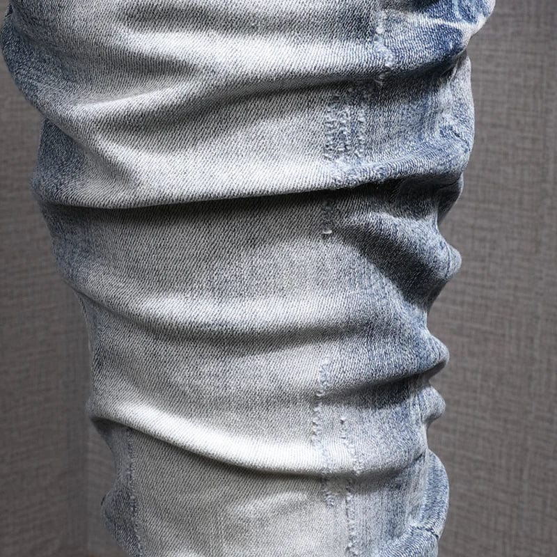 Showlu Men's retro light blue slim fit ripped stretch denim jeans with distressed details and vintage casual style.