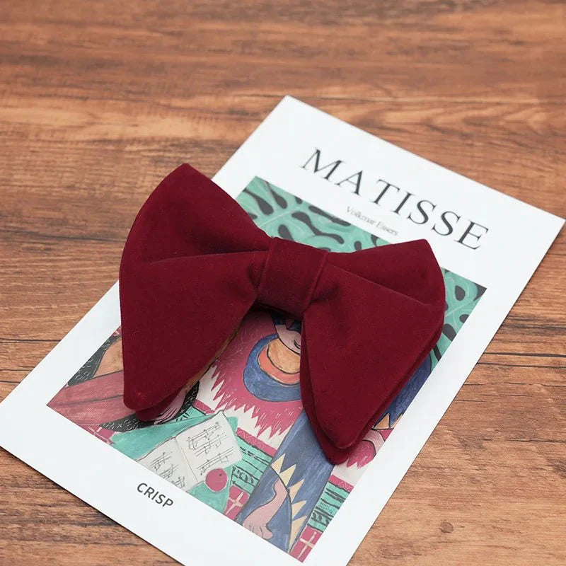 Black velvet oversized bow tie and pocket square set for tuxedos, featuring red, navy, and white accents with green handkerchief.