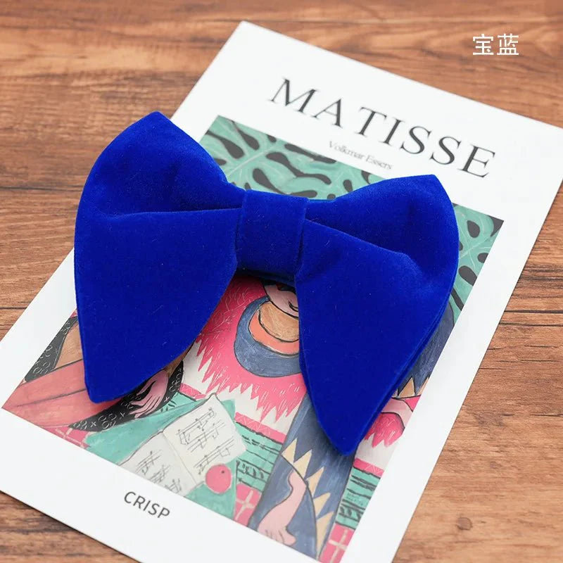 Black velvet oversized bow tie and pocket square set for tuxedos, featuring red, navy, white, and green accents.