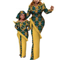 Mom and daughter wearing matching Ankara African wax print maxi dresses made of cotton, featuring vibrant traditional patterns.
