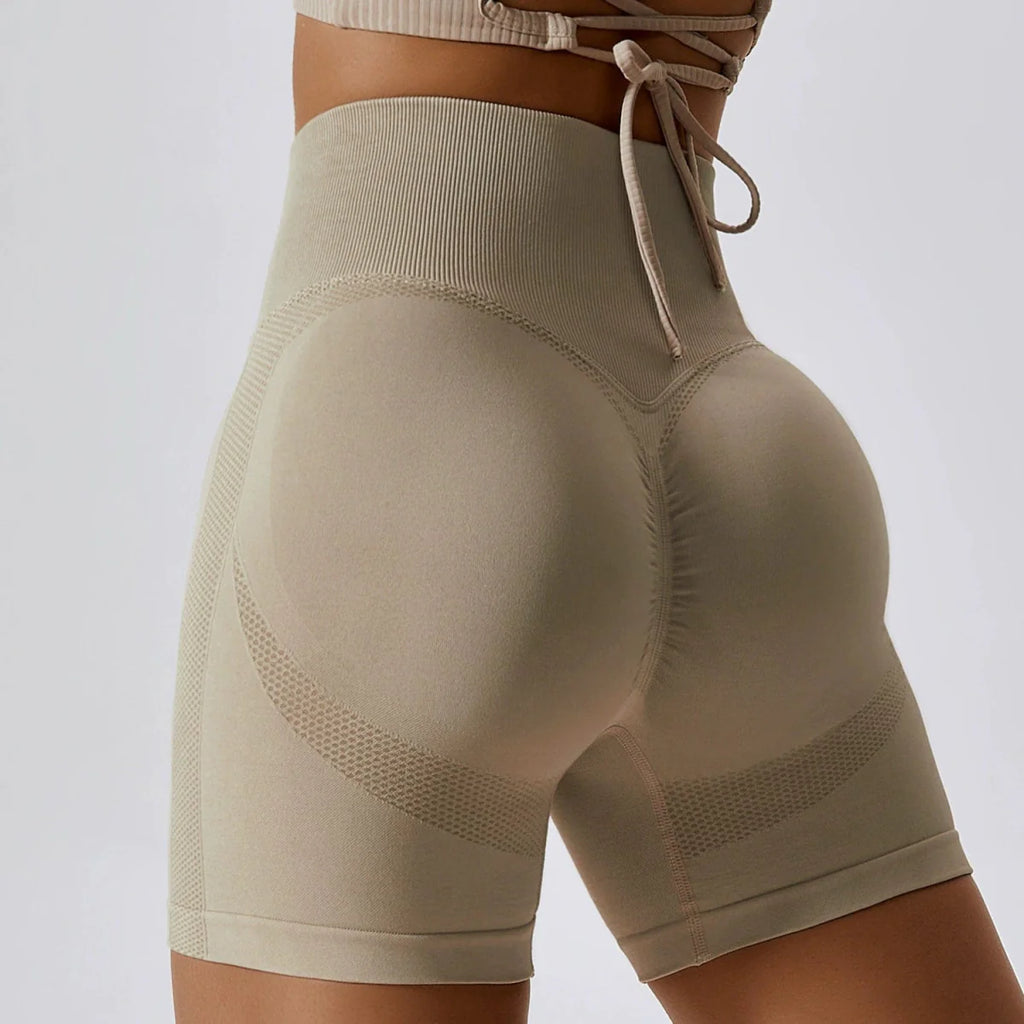 Showlu high waist seamless yoga shorts in peach, designed for fitness, running, and hip-slimming workouts.