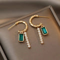 Green crystal rhinestone earrings featuring trendy alloy design, stylish fashion jewelry with sparkling gemstone accents.