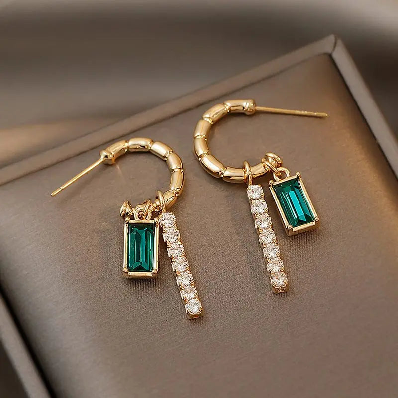 Green crystal rhinestone earrings featuring trendy alloy design, stylish fashion jewelry with sparkling gemstone accents.