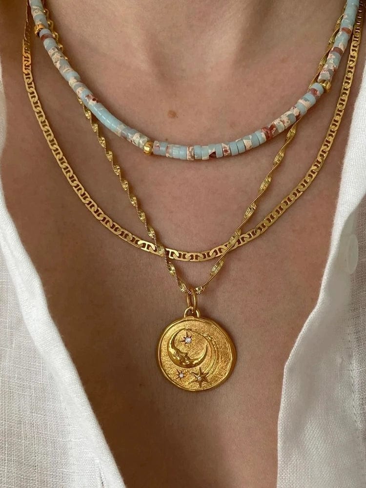 Turquoise star and moon necklace with vintage gold coin brass pendant, showing a delicate chain and celestial design.