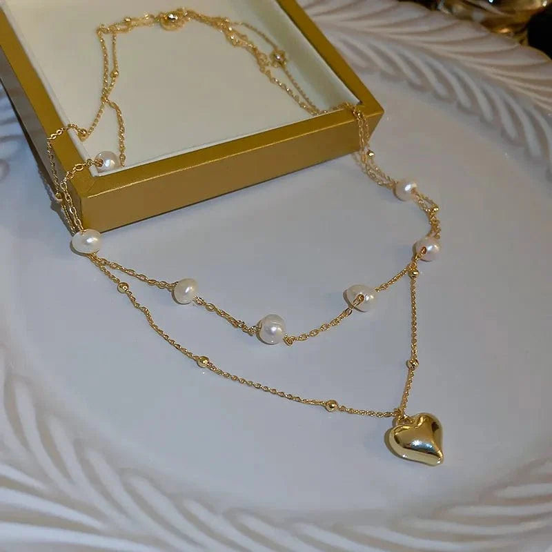 Elegant double-layer pearl love pendant necklace by NEULRY, showcasing copper jewelry design for women, perfect for weddings and parties.
