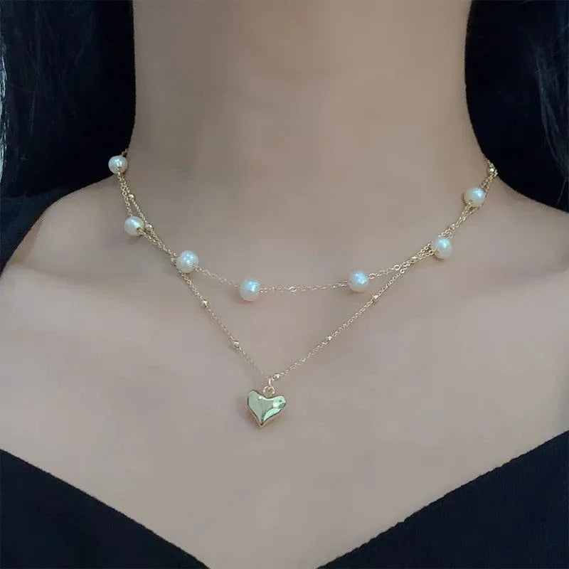 Elegant double-layer pearl love pendant necklace by Showlu Fashion for women, perfect for weddings and special occasions.