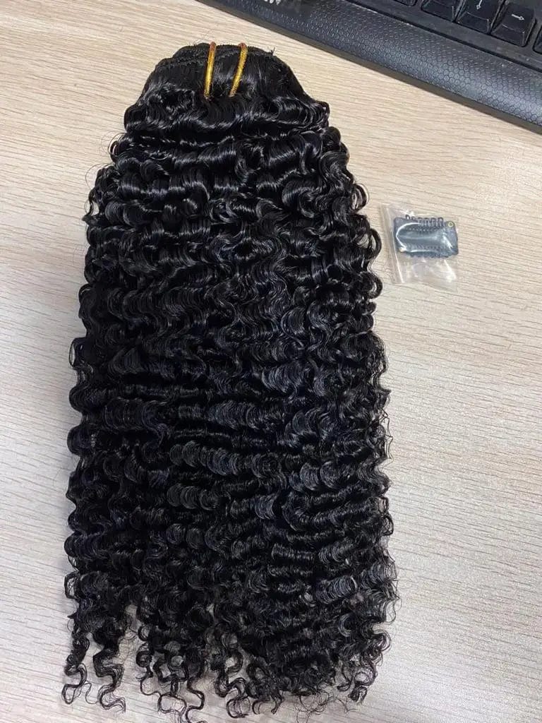 Afro kinky curly clip-in hair extensions by Showlu Fashion Store, 100% raw Brazilian virgin hair in natural dark shades.