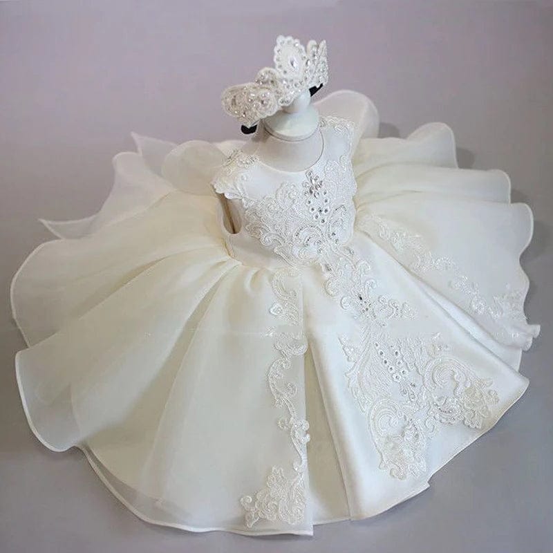 Elegant white lace baby girl baptism dress with beads and bow, perfect for birthday parties and special occasions.