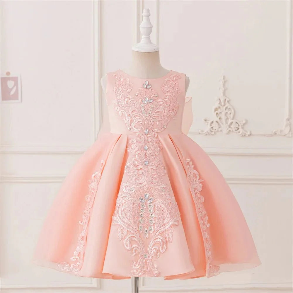 Elegant white baptism dress for baby girl with lace, beads, and bow, perfect for birthdays or special occasions.