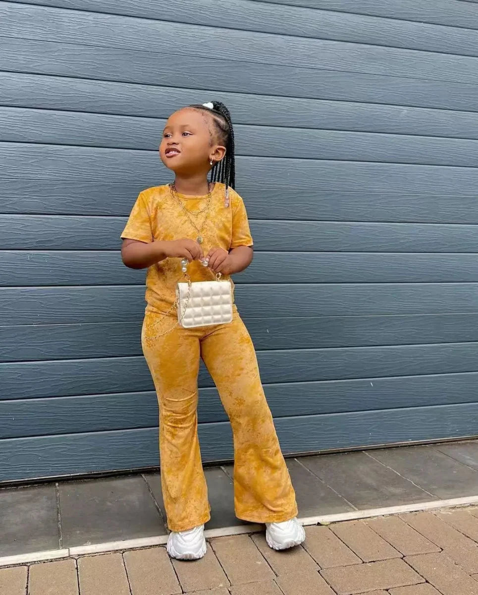 Girls' 2-piece clothing set with short sleeve top and flared pants by Showlu Fashion Store, featuring casual printed design for ages 3-8.