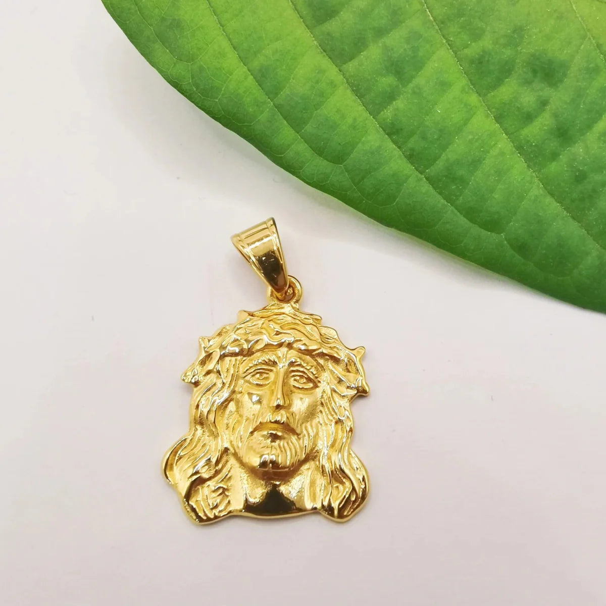 Gold stainless steel Jesus charm pendant necklace for women and men, stylish jewelry for parties and gifts.