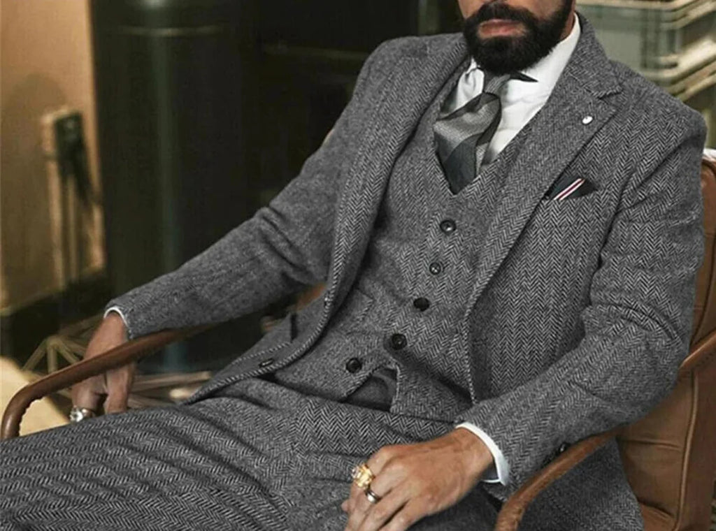Gray herringbone wool tweed men's 3-piece winter suit with slim fit, jacket, vest, and pants, ideal for formal and wedding occasions.