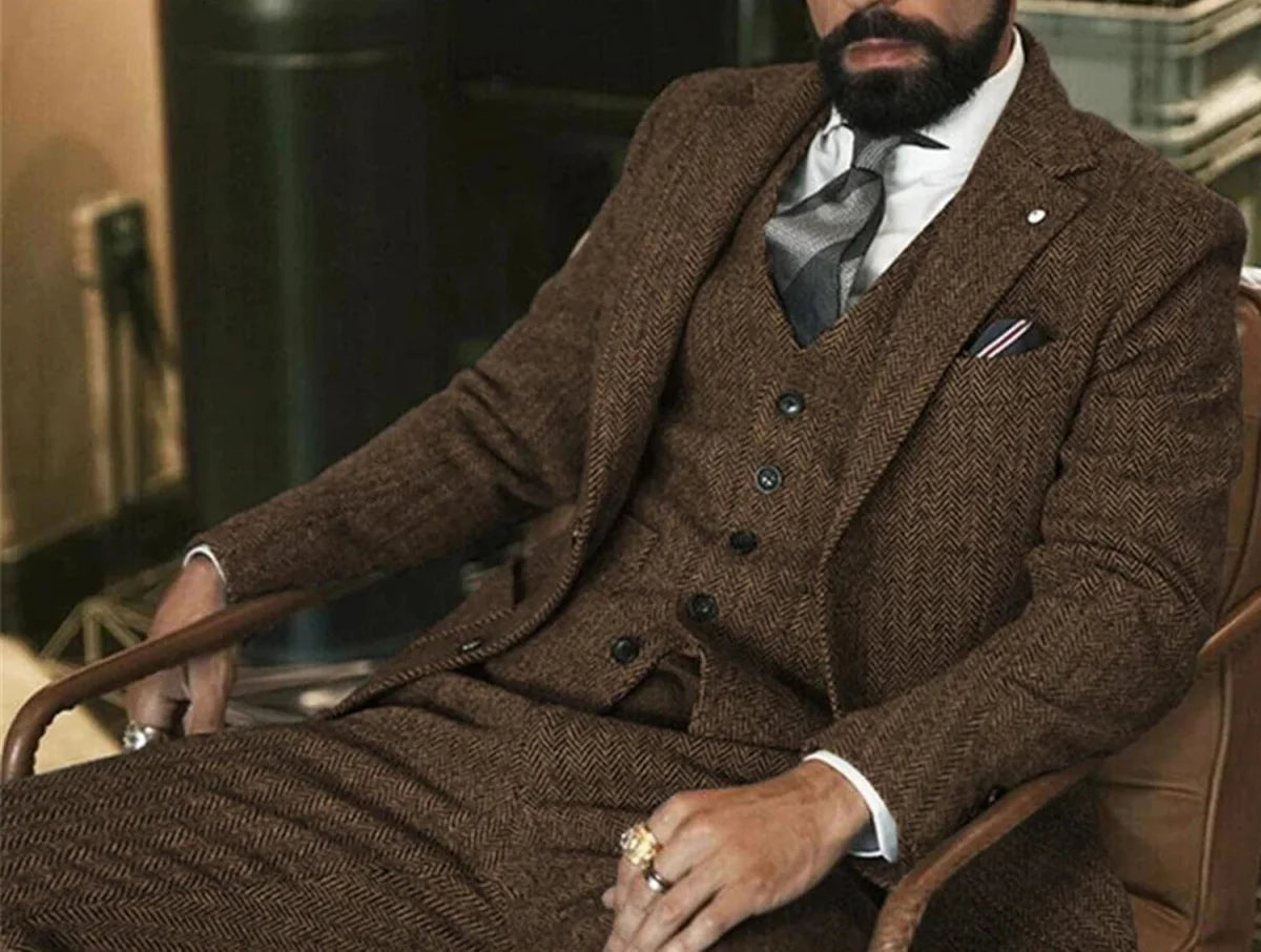Gray herringbone wool tweed men's 3-piece winter suit with slim fit, jacket, vest, and pants, ideal for formal or wedding occasions.