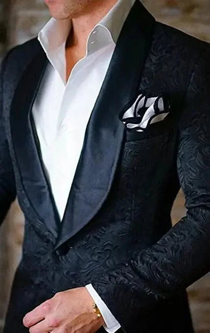 Ivory patterned men's tuxedo with shawl lapel, jacket, pants, and tie, designed for grooms and formal weddings.