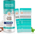 GuruNanda coconut oil pulling travel sachets with essential oils, 7-pack, featuring Mickey D design for fresh breath and healthy gums.