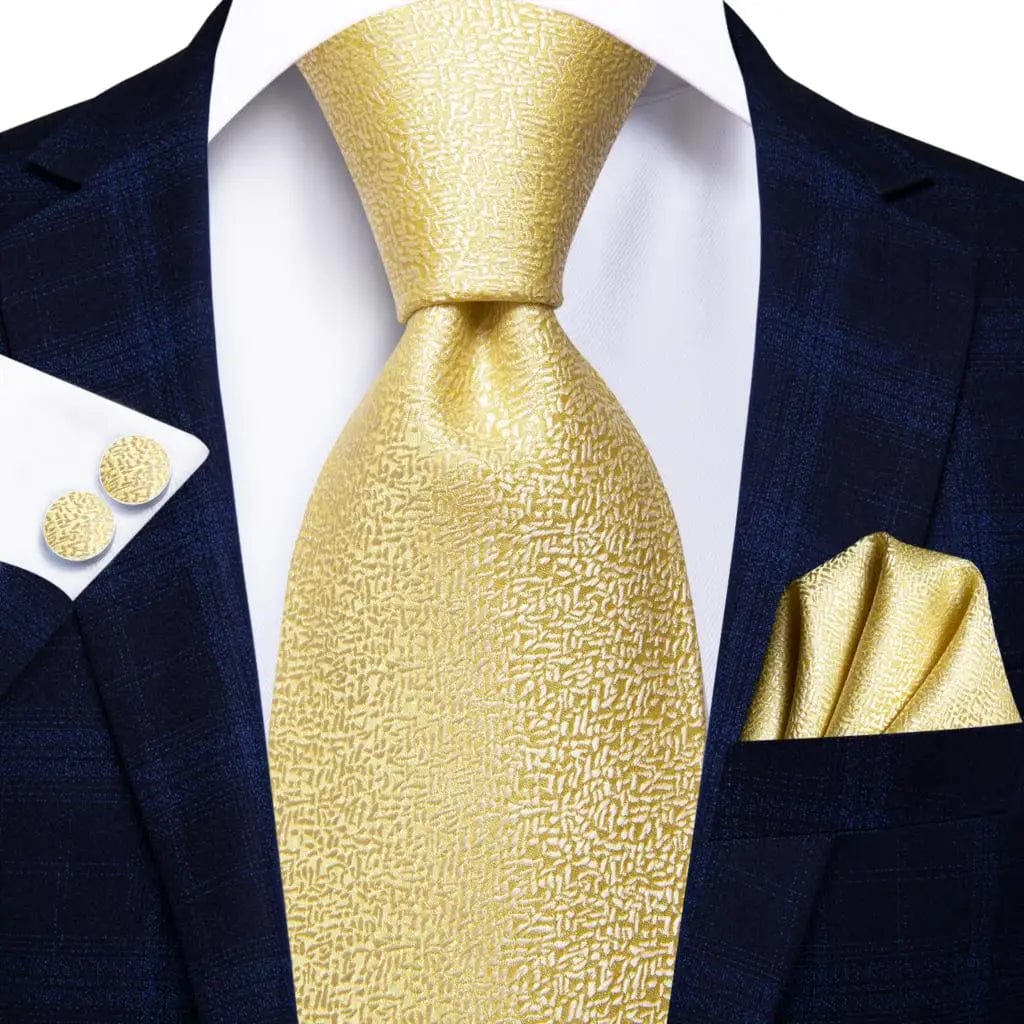 Hi-Tie solid gold yellow silk tie set for men with matching handkerchief and cufflinks, perfect for wedding or business attire.