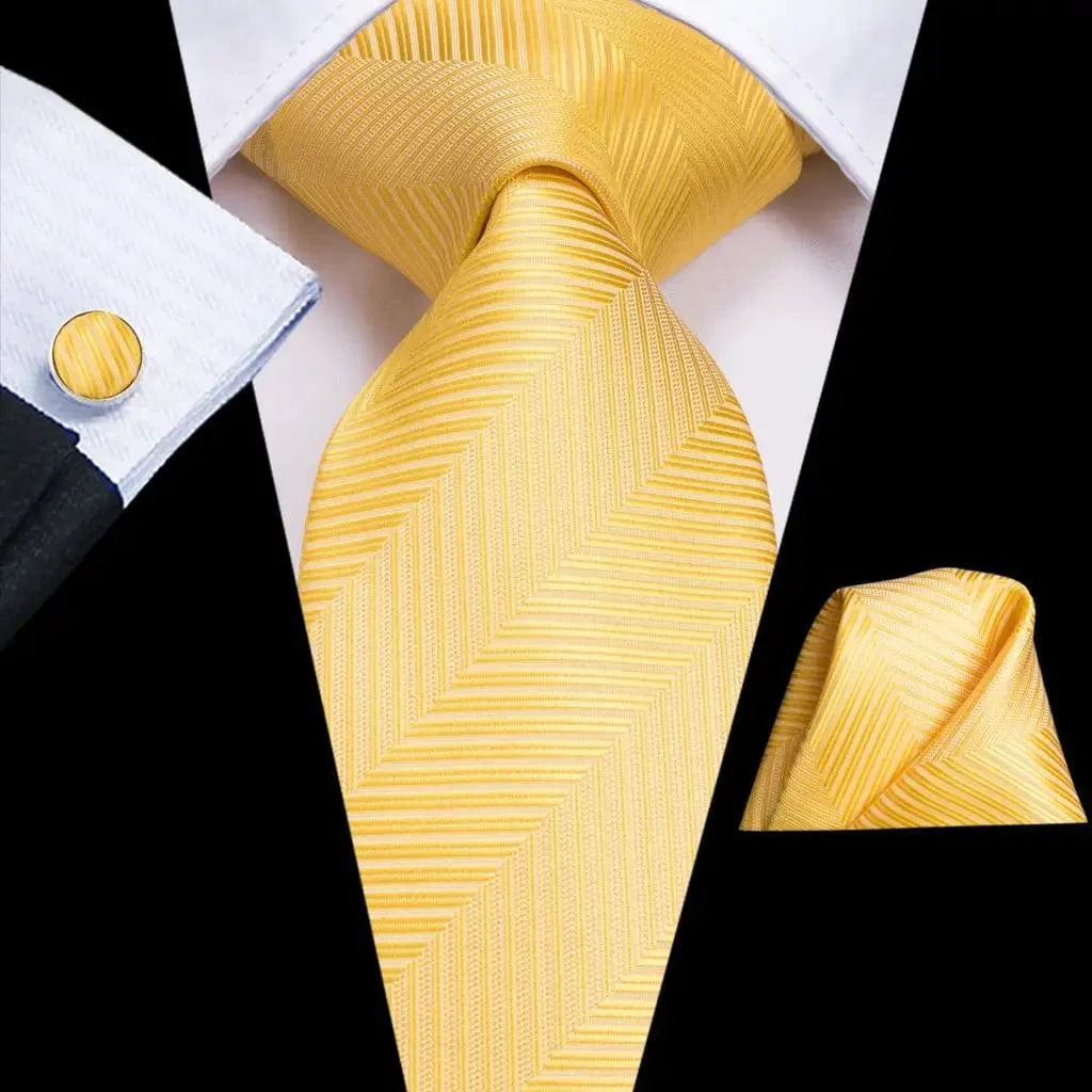 Hi-Tie solid gold yellow silk tie set with matching handkerchief and cufflinks for men, suitable for wedding and business attire.