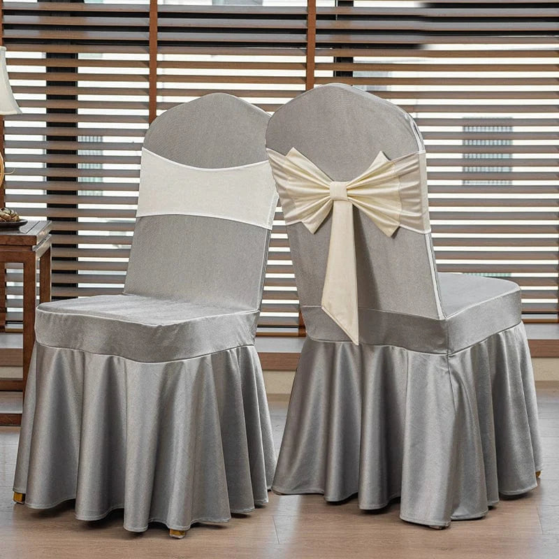 High-end satin bow chair cover for hotel, wedding, and banquet events, featuring elegant draping and a luxurious finish.