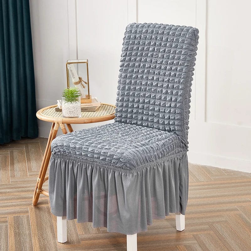 Seersucker stretch dining chair cover with elastic skirt for banquet or wedding chairs, showcasing elegant upholstery and fit.