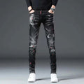 Showlu Men's Ripped Skinny Jeans in black with paint splash design, casual denim with distressed patches and a fitted pencil style.
