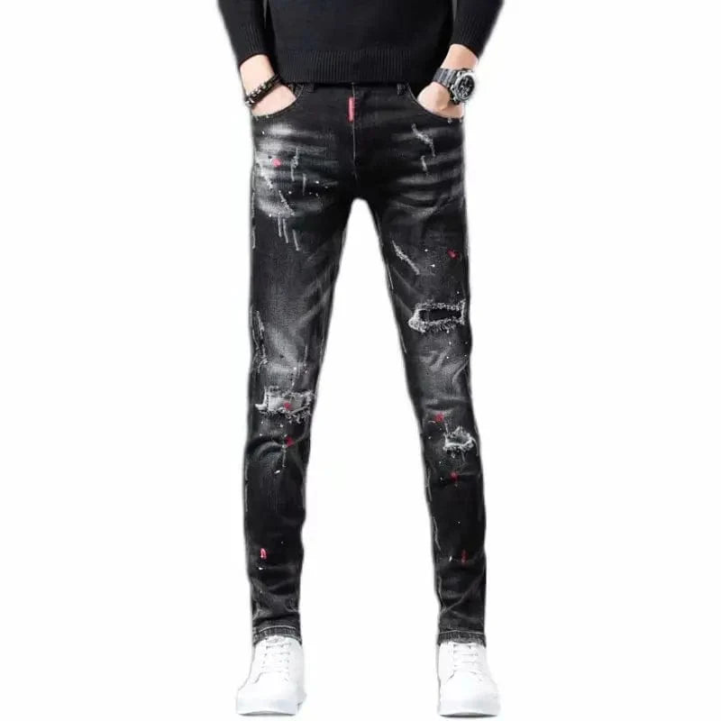 Black Showlu men's ripped skinny jeans with paint splash design, casual denim pencil pants with distressed details and patch accents.