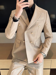 A slim-fit beige double-breasted suit jacket with gold buttons worn over a black shirt.