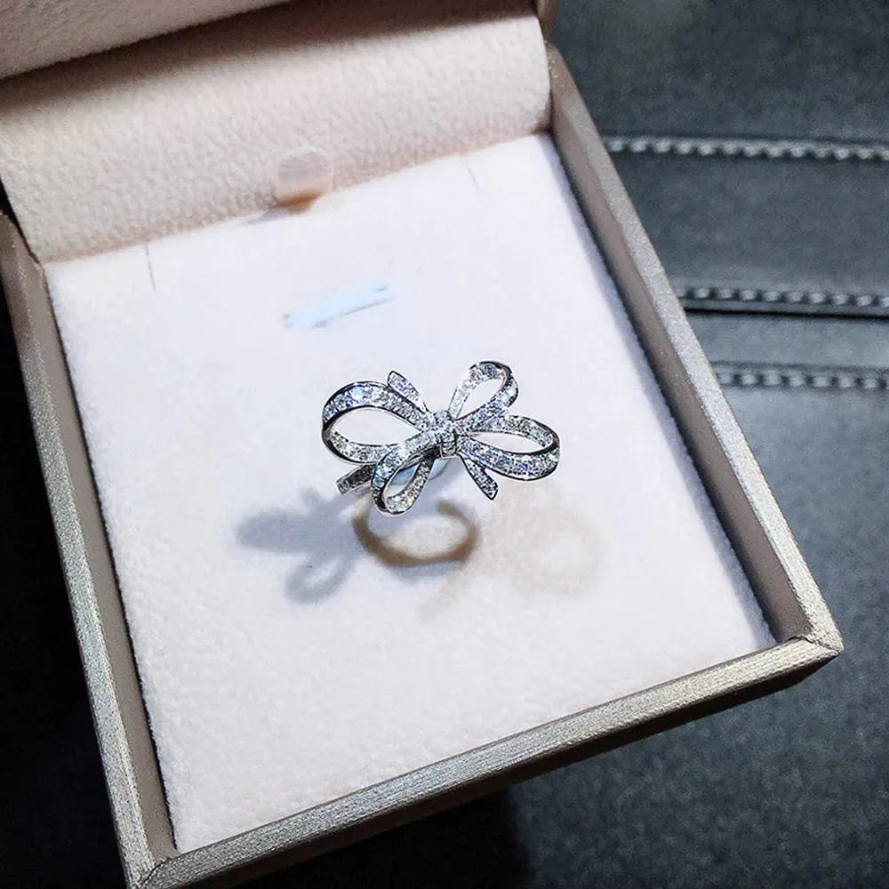Showlu Romantic Bow Cubic Zirconia Wedding Band Ring for Women, elegant jewelry with sparkling stones and intricate bow design.
