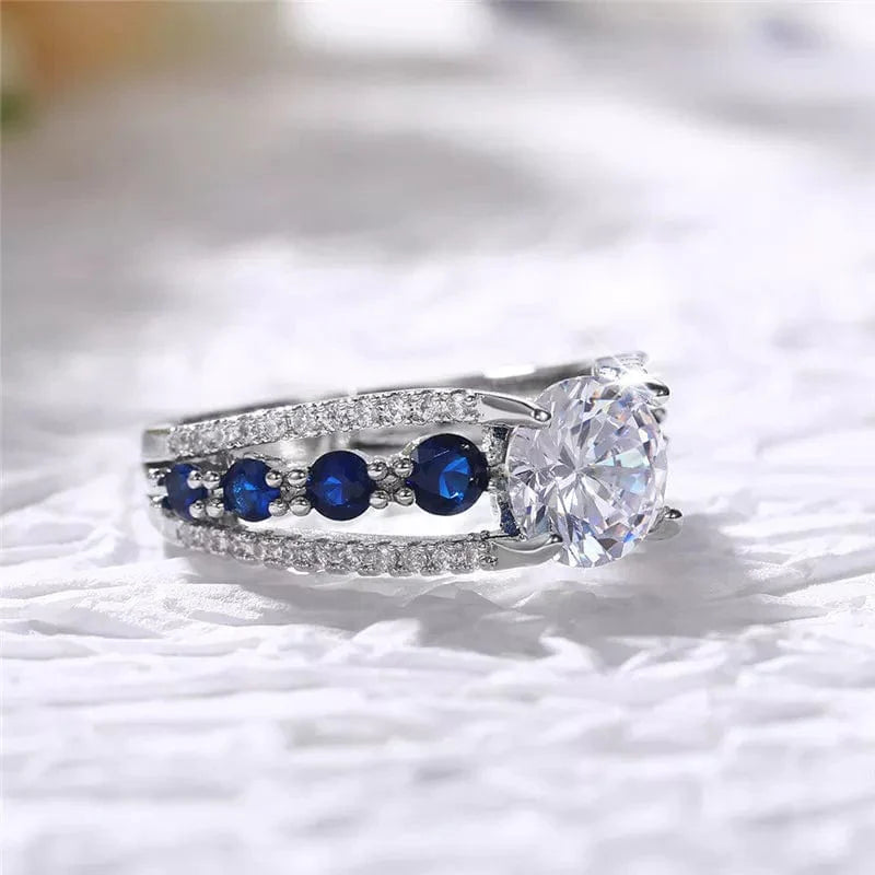 Showlu women's blue and white round CZ wedding band in brass, stylish party ring with elegant design and trendy jewelry appeal.