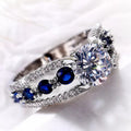 Showlu women's blue and white round CZ wedding band made of brass, featuring elegant floral design, perfect for special occasions.