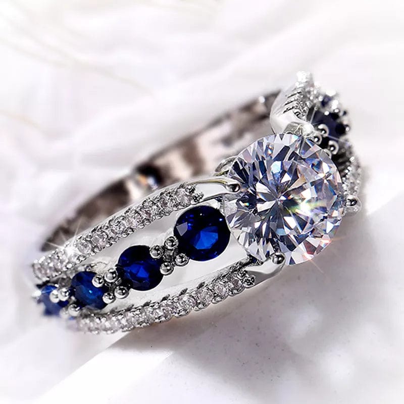 Showlu women's blue and white round CZ wedding band made of brass, featuring elegant floral design, perfect for special occasions.