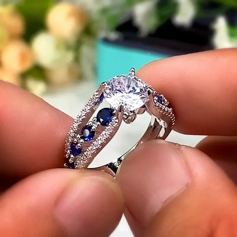 Showlu Women's blue and white round CZ wedding band made of brass, featuring a trendy, elegant design for special occasions and gifts.