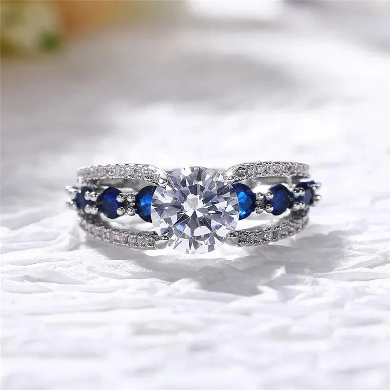 Showlu Women's blue and white round CZ wedding band made of brass, stylish party ring with elegant design.