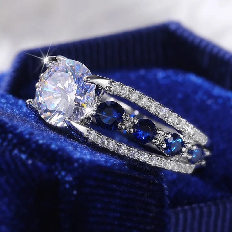 Showlu Women's blue and white round CZ wedding band made of brass, stylish party ring with elegant design and gemstone accents.