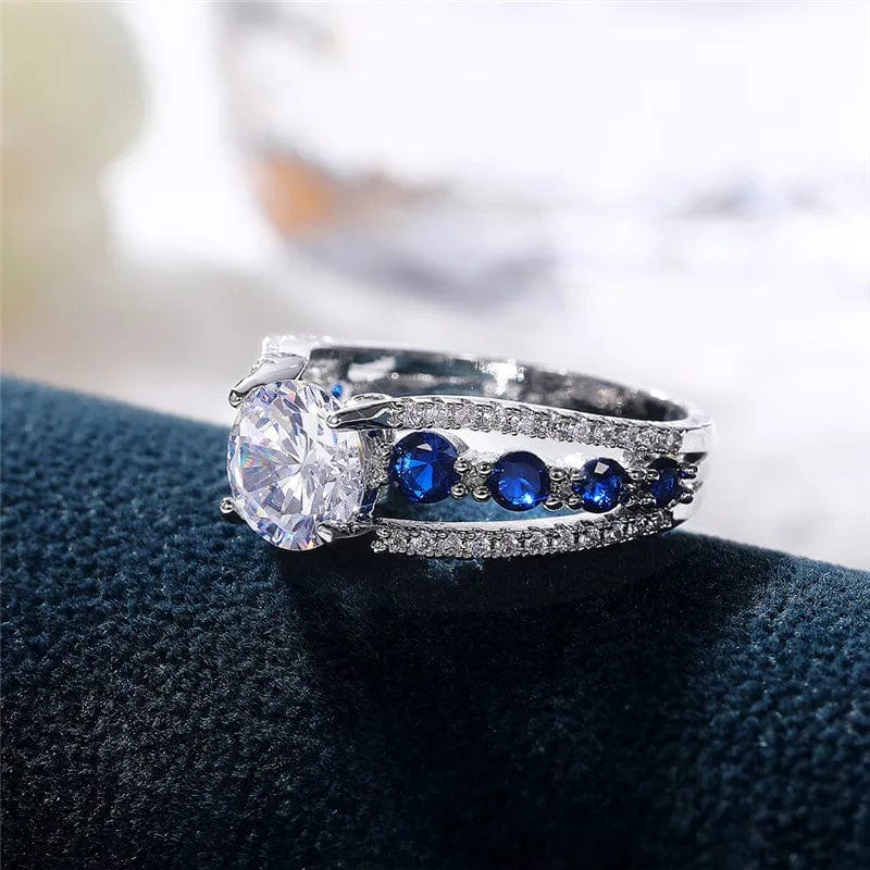 Showlu Women's blue and white round CZ wedding band made of brass, stylish party ring with intricate design and trendy jewelry appeal.