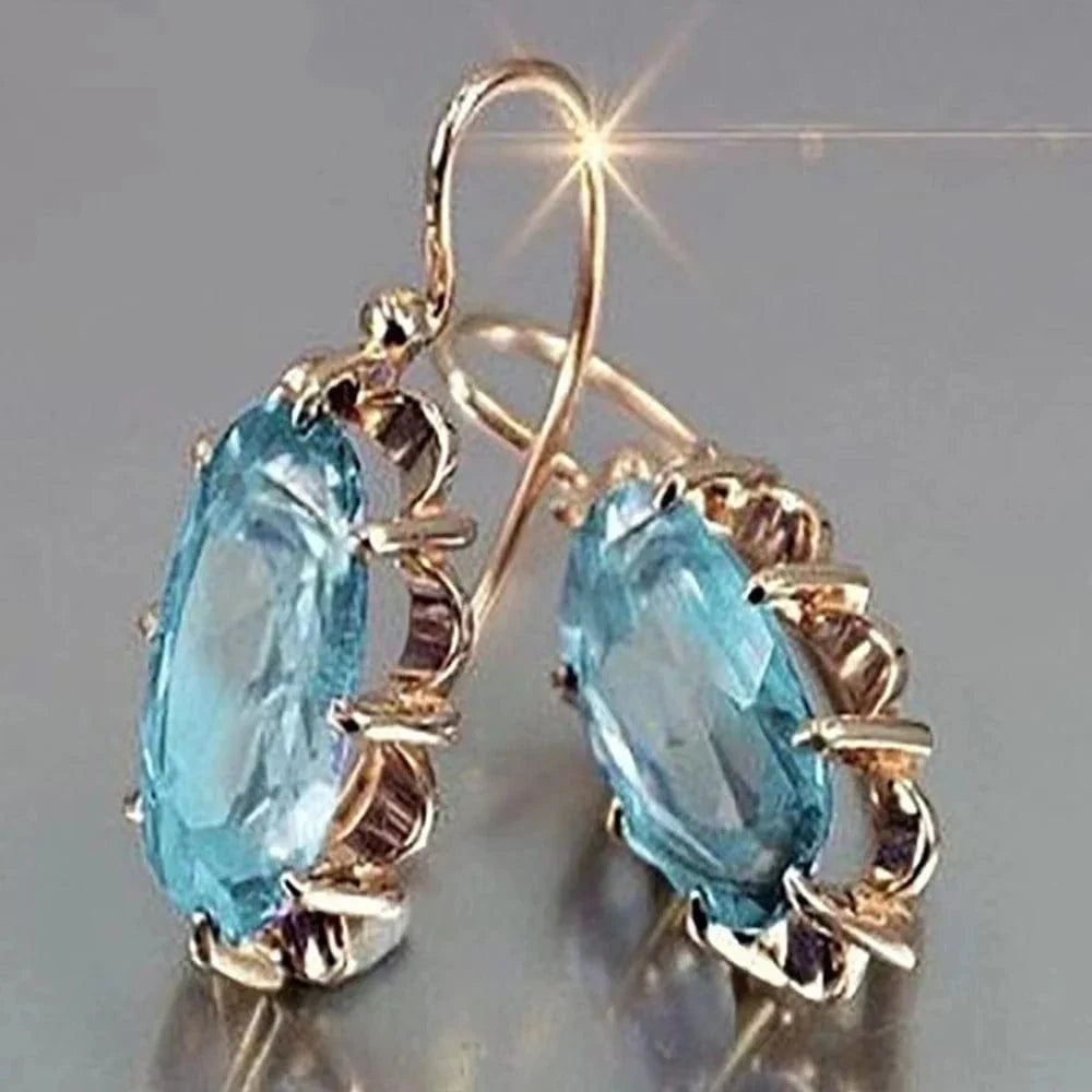 Huitan women's oval cubic zirconia dangle earrings in elegant brass with intricate design, stylish luxury jewelry for women.