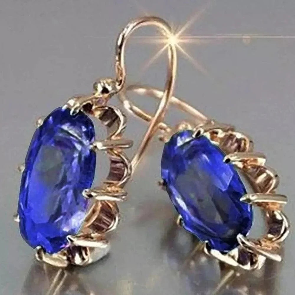 Huitan women's oval cubic zirconia dangle earrings with elegant brass design, showcasing luxury and aesthetic jewelry style.