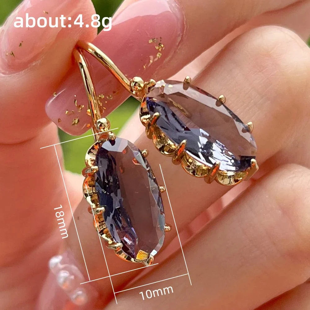 Huitan women's oval cubic zirconia dangle earrings with elegant brass design, showcasing luxury jewelry style.