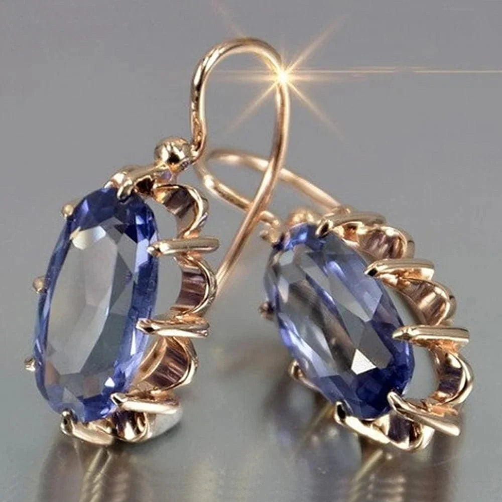 Huitan women's oval cubic zirconia dangle earrings in elegant brass, showcasing a luxurious and stylish jewelry design.