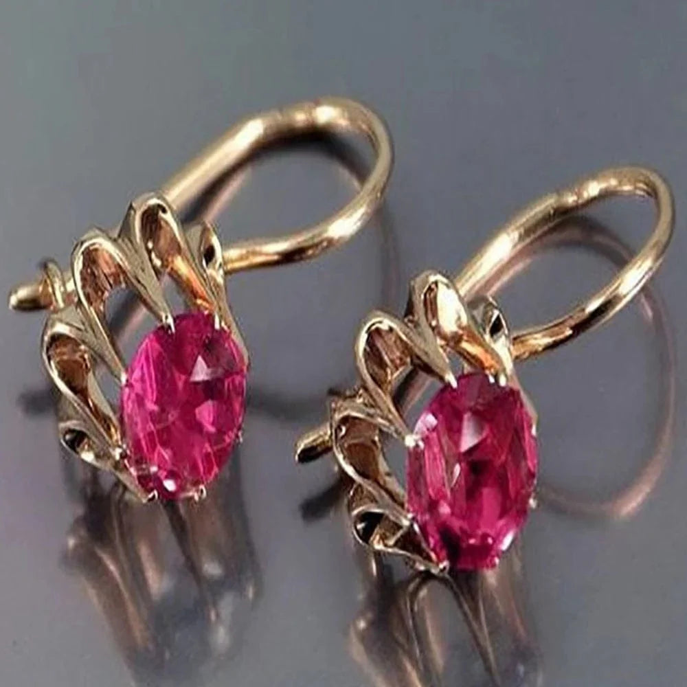 Huitan Women's Oval Cubic Zirconia Dangle Earrings in elegant brass, showcasing a luxurious and stylish jewelry design.