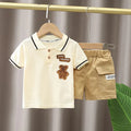 Baby boy summer clothing set with white cotton polo shirt and navy shorts, casual toddler outfit for warm weather.