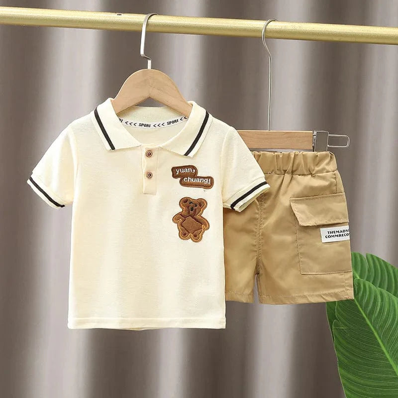 Baby boy summer clothing set with white cotton polo shirt and navy shorts, casual toddler outfit for warm weather.