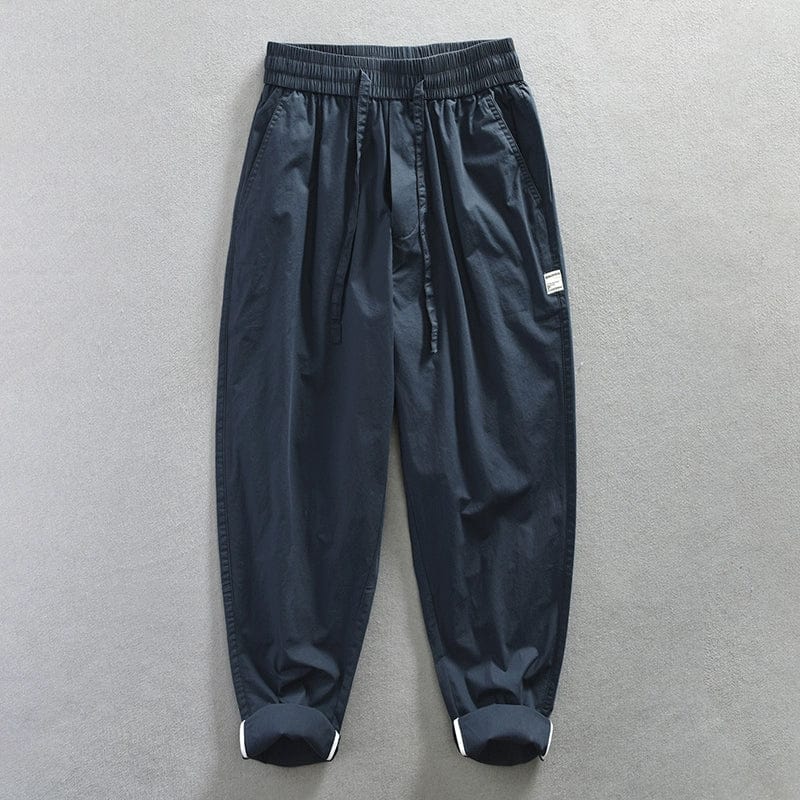 Jereno Ice Silk Cotton Tapered Pants in minimalist style, showing thin, quick-dry fabric with a sleek fit and ninth-length design.