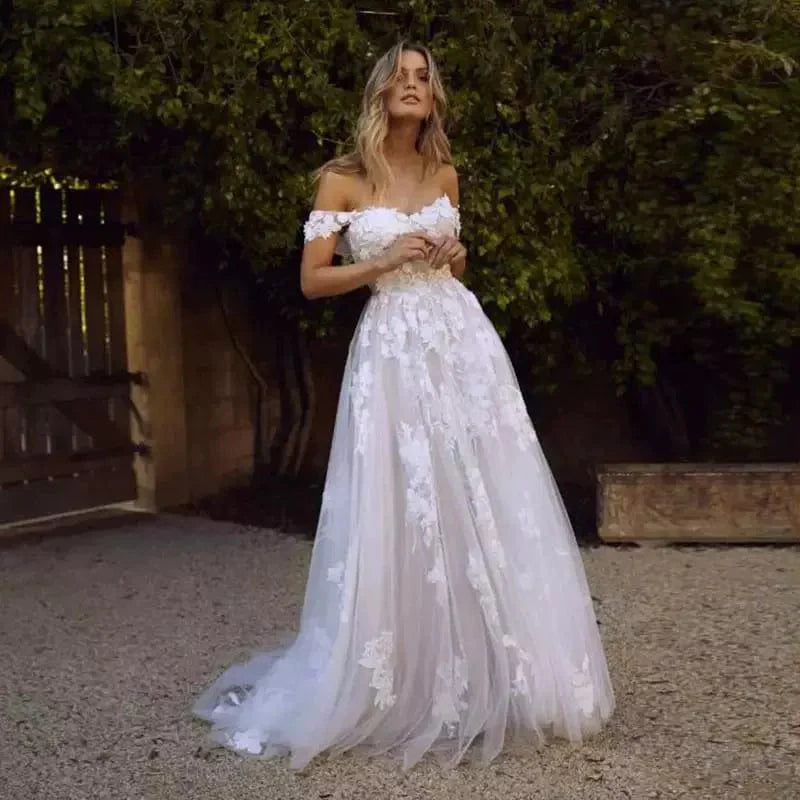 Elegant off-shoulder lace wedding gown by Showlu Fashion featuring intricate lace details and a flowing bridal silhouette.