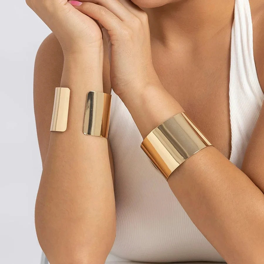 Gold-colored wide cuff bracelet with a smooth finish and open design, featuring a punk style for women’s fashion and jewelry.