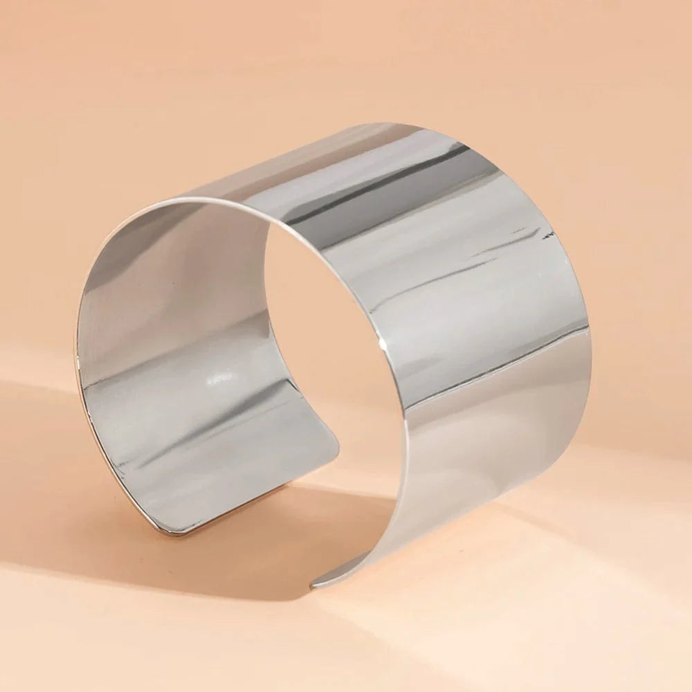 Gold-colored wide cuff bracelet with a smooth finish, open design, punk style, suitable for women, fashion jewelry accessory.